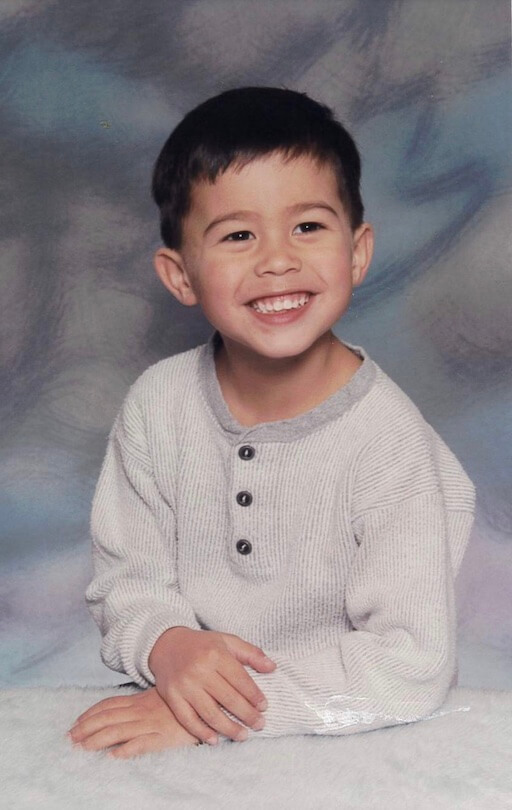 A smiling childhood photo of Anthony.